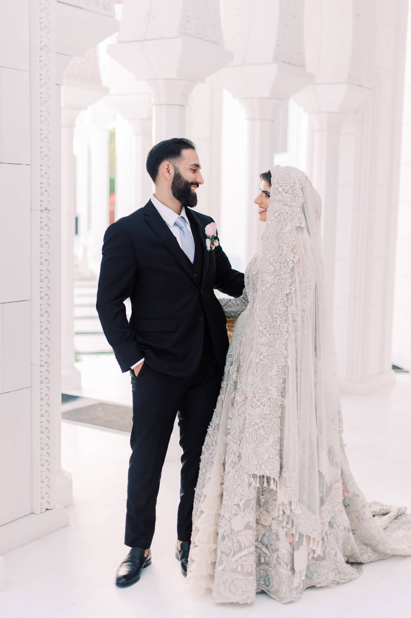 couple taking wedding photos outside mosque/masjid wedding venue for nikah and interfaith ceremonies